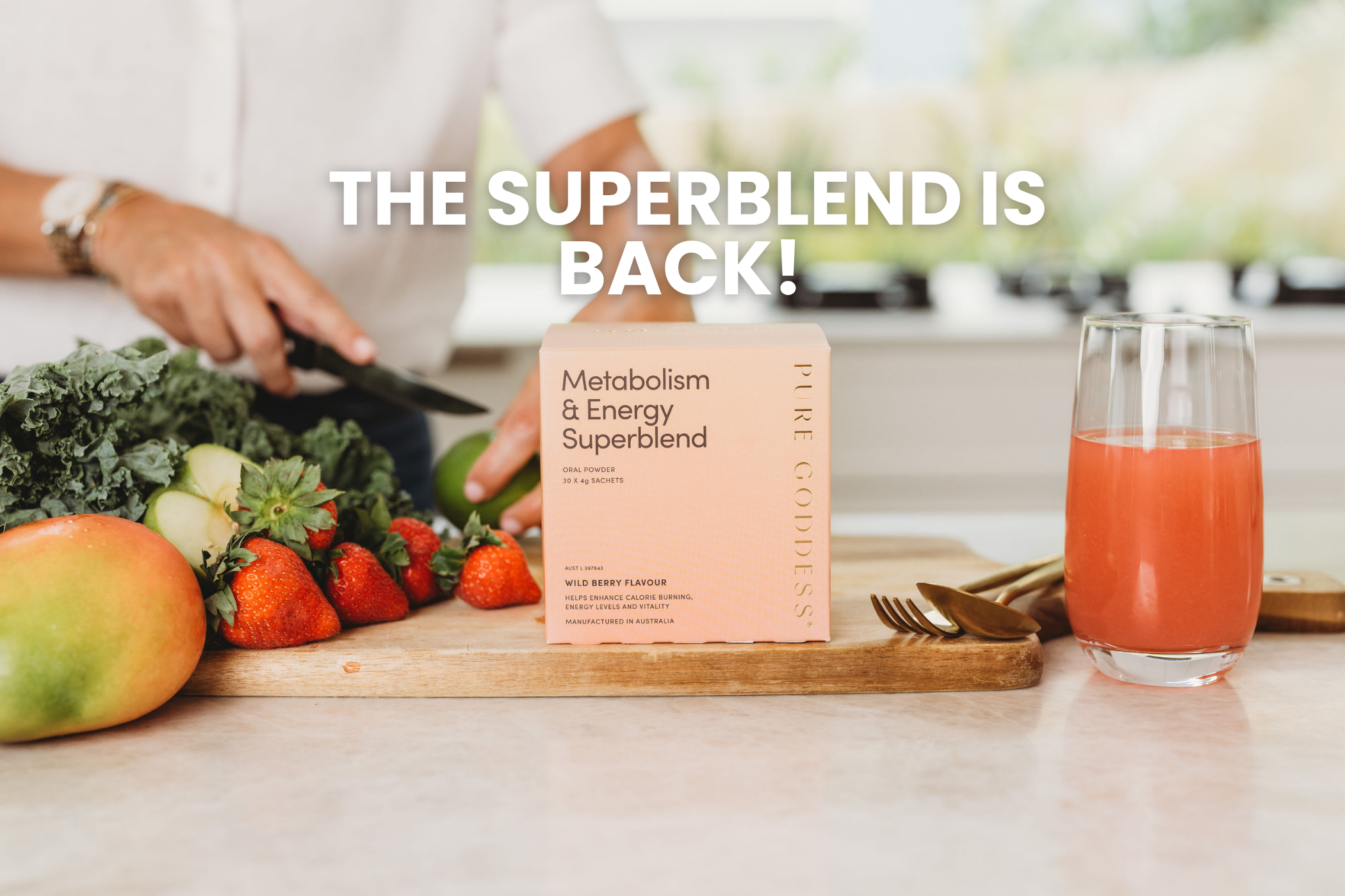 Metabolism & Energy Superblend box on a kitchen counter with fresh produce and a glass of juice.